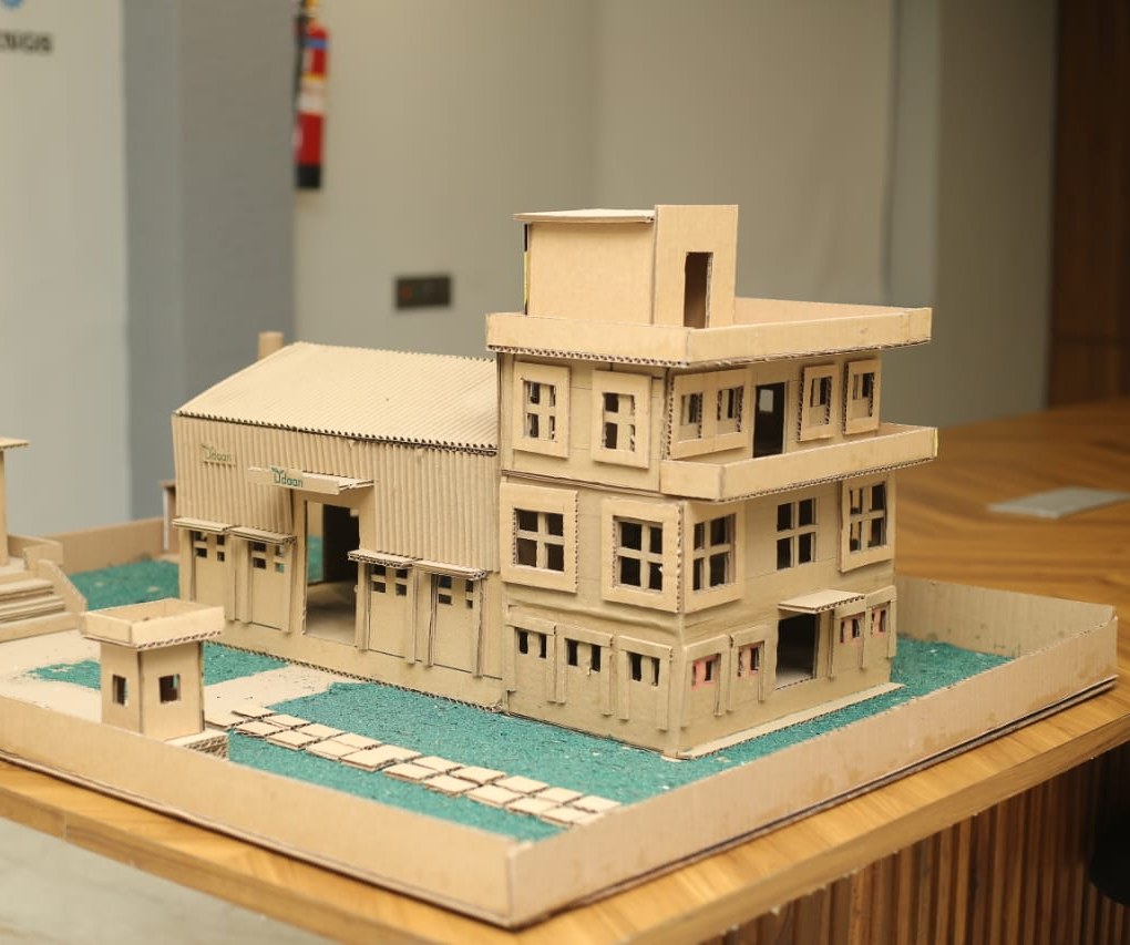 An architectural model built entirely from corrugated paper